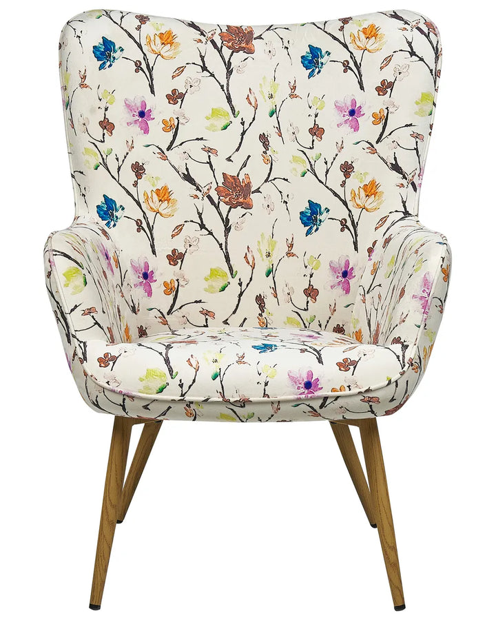 An upholstered bench or ottoman with a cream fabric seat covered in a colorful floral and branch print, supported by four angled wooden legs with black tips, shown on a plain white background.
