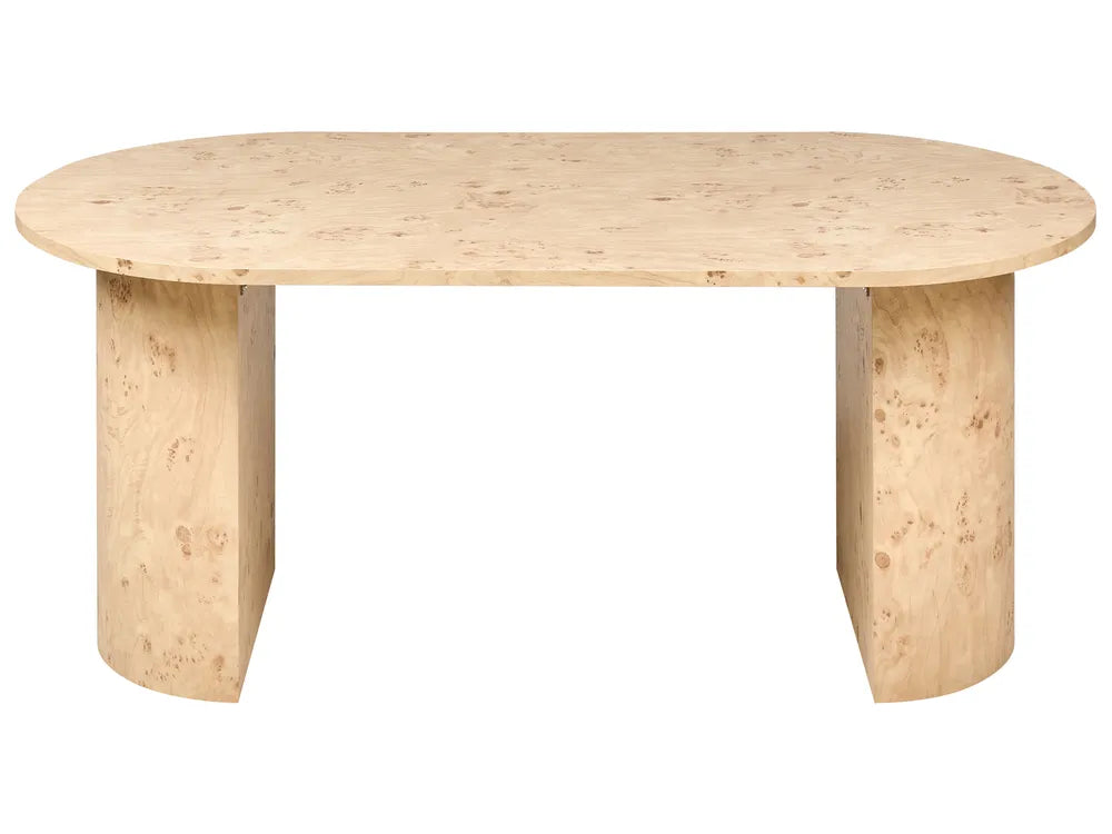 An oval dining table made of light natural wood with prominent burl grain, featuring two thick cylindrical pedestal legs, shown against a plain white background.