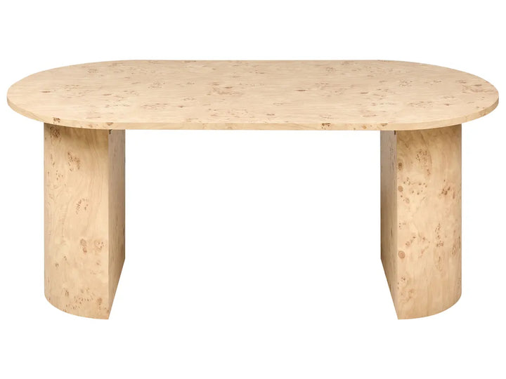 An oval dining table made of light natural wood with prominent burl grain, featuring two thick cylindrical pedestal legs, shown against a plain white background.