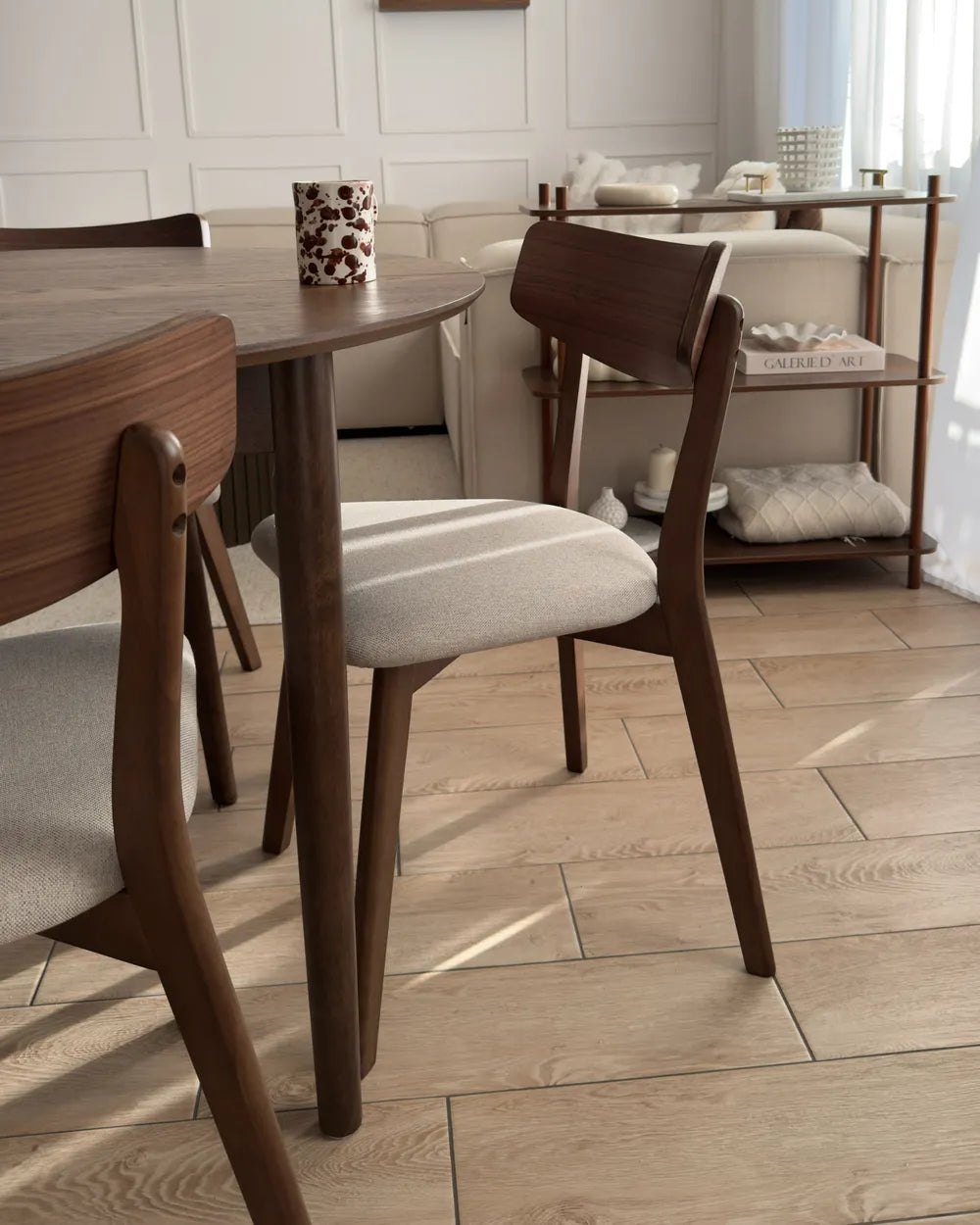 Wooden chair with a beige cushion.