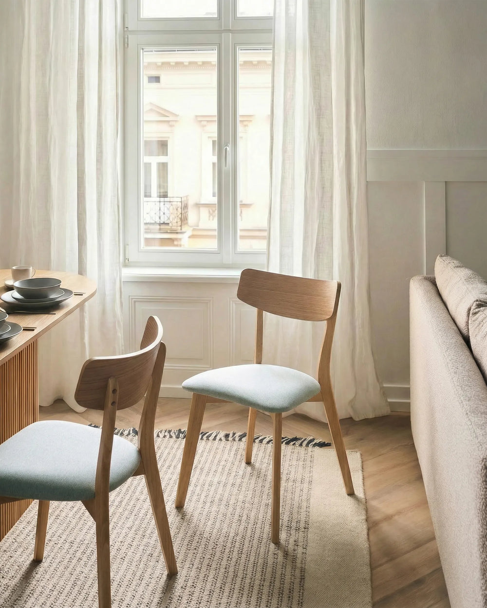 Wooden chair with a light green cushion.