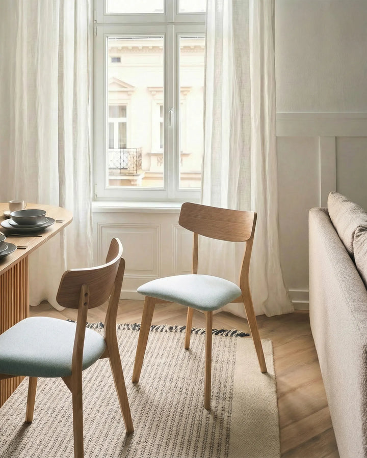 Wooden chair with a light green cushion.