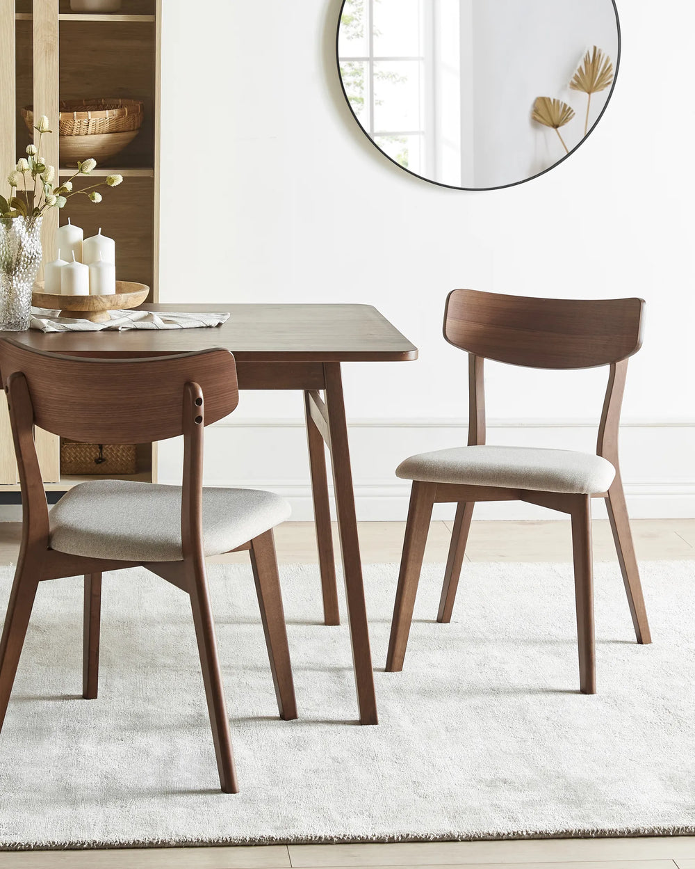 Wooden chair with a beige cushion.