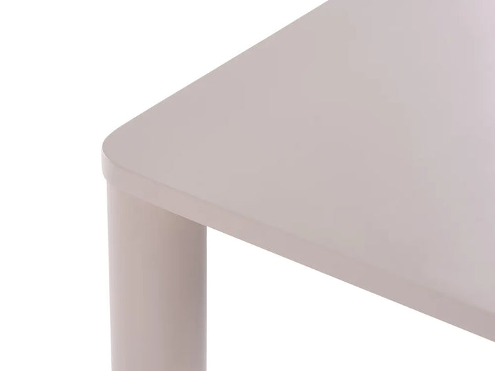 Close-up of a light gray table corner with a cylindrical leg on a white background.