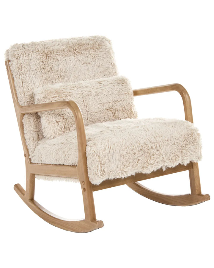 A wooden rocking chair with thick, fluffy cream sheepskin-style upholstery on the seat, backrest, and matching throw pillow, shown against a plain white background.