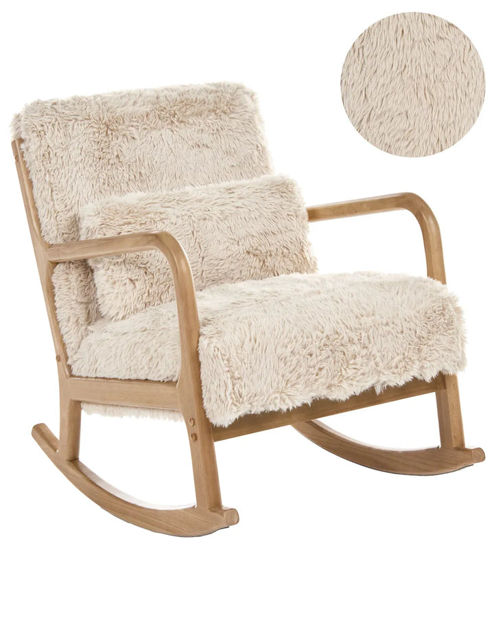 A wooden rocking chair with thick, fluffy cream-colored faux fur upholstery on the seat, backrest, and matching throw pillow, shown against a plain white background with a circular fabric texture inset in the upper right.