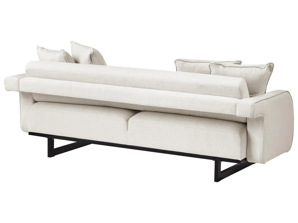 A modern upholstered sofa in a light cream or off-white fabric with a low black metal frame, shown against a plain white background.