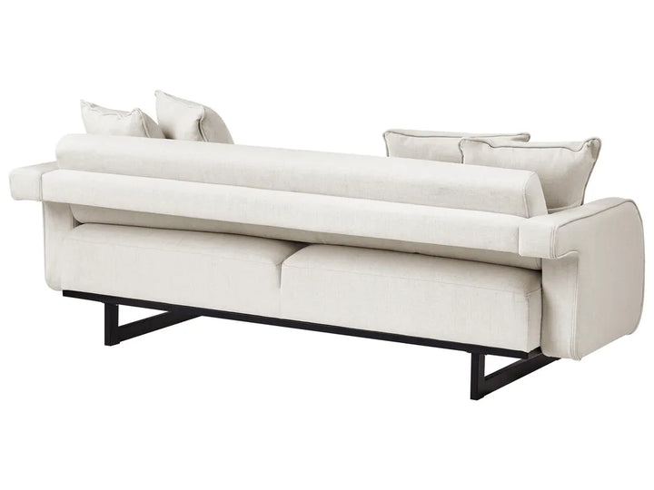 A modern upholstered sofa in a light cream or off-white fabric with a low black metal frame, shown against a plain white background.