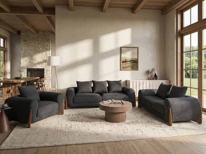 Modern living room with gray sofas, wooden coffee table, and large windows.