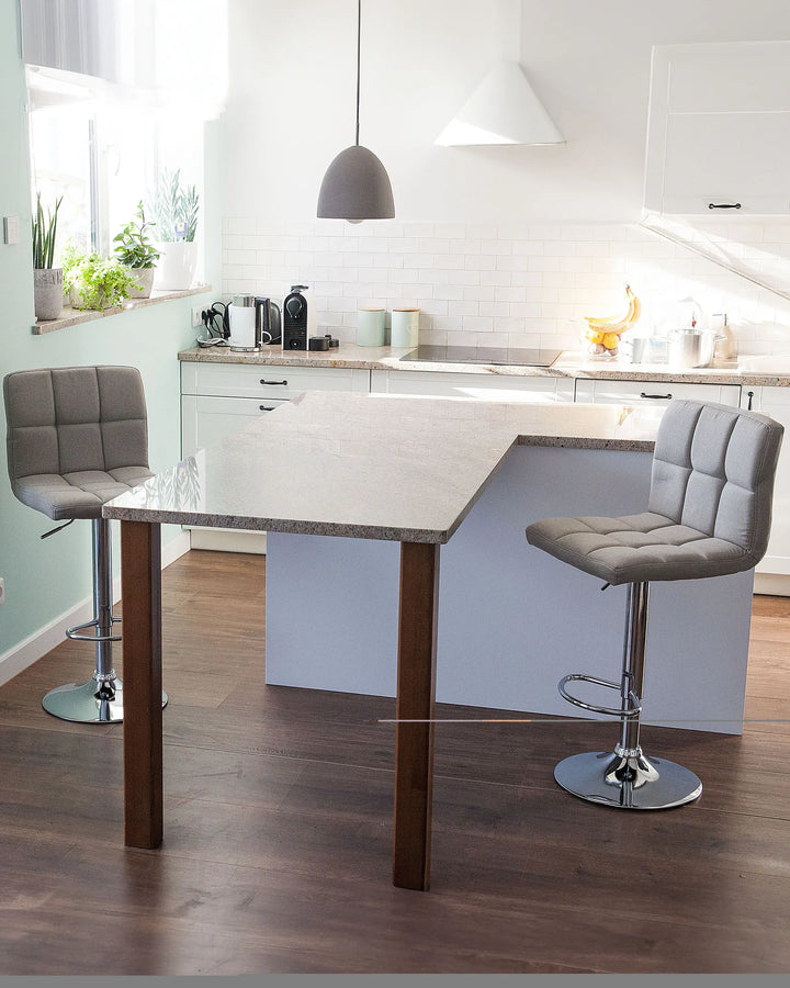 Modern kitchen with a wooden dining table and gray bar stools.