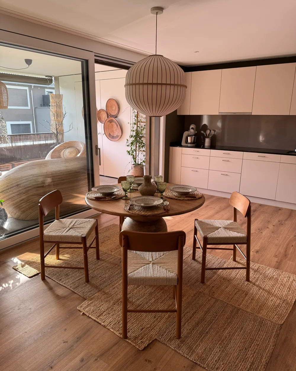 Dining area with round table and chairs in a modern kitchen setting.