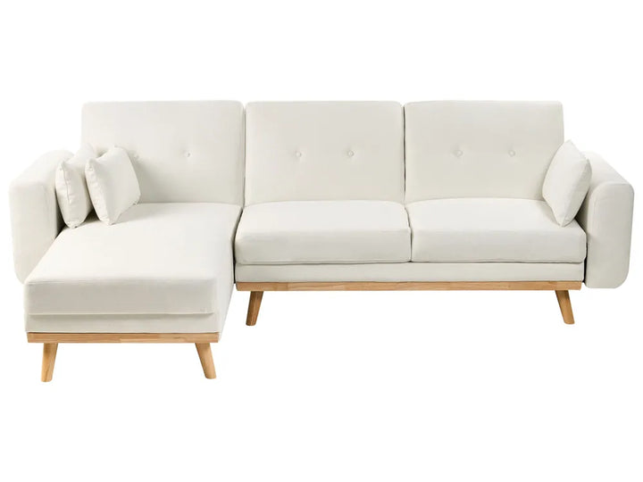 A modern sectional sofa in off-white fabric with a left-facing chaise lounge, tufted back cushions, and light natural wood legs, shown against a plain white background.