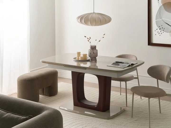 Dining room with a modern table and chairs in a well-lit room.