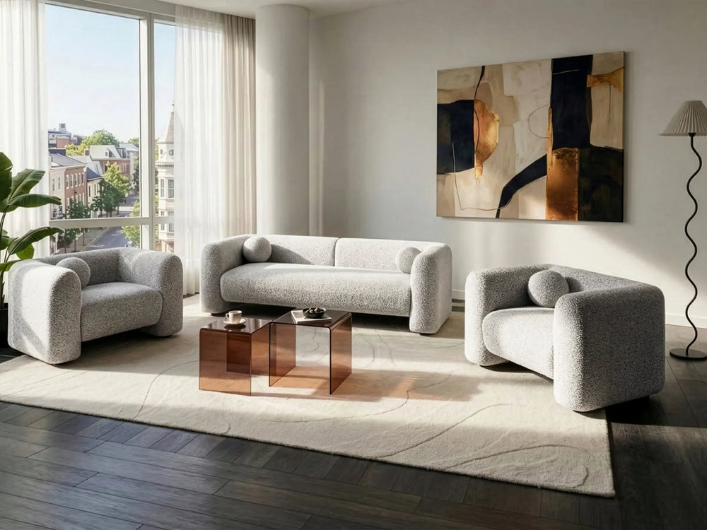 Modern living room with gray sofa set, abstract painting, and large windows.