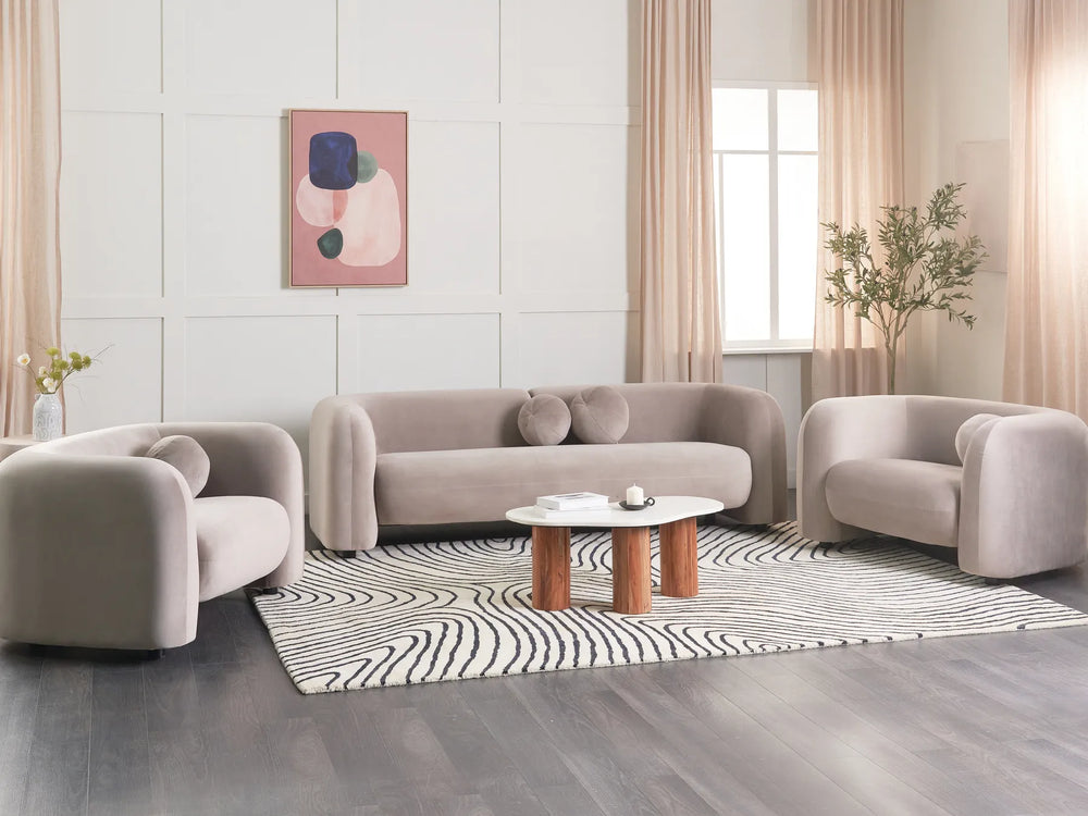 Modern living room with beige sofa set, coffee table, and decorative elements.