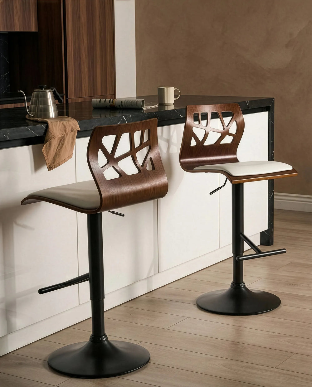 Two brown bar stools with black bases on a kitchen counter.