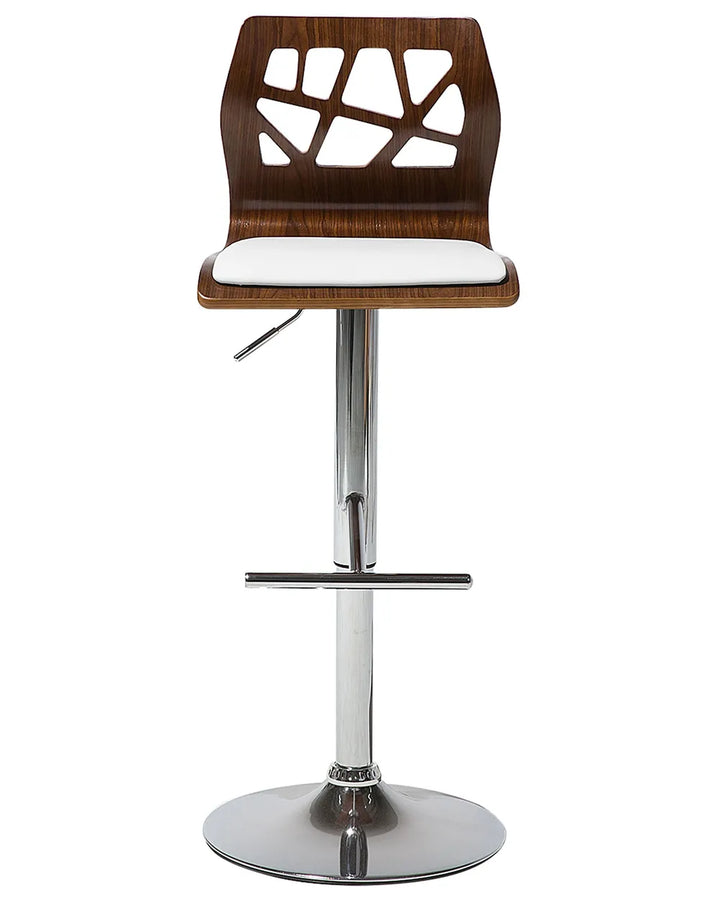 A modern bar stool with a dark brown wood grain seat and backrest featuring geometric cutouts, a white upholstered seat cushion, and a chrome adjustable pedestal base with a circular footrest.