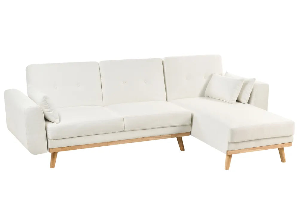White sectional sofa with wooden legs on a white background