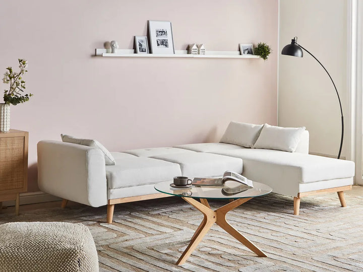 Modern living room with a white sofa, coffee table, and decorative items.