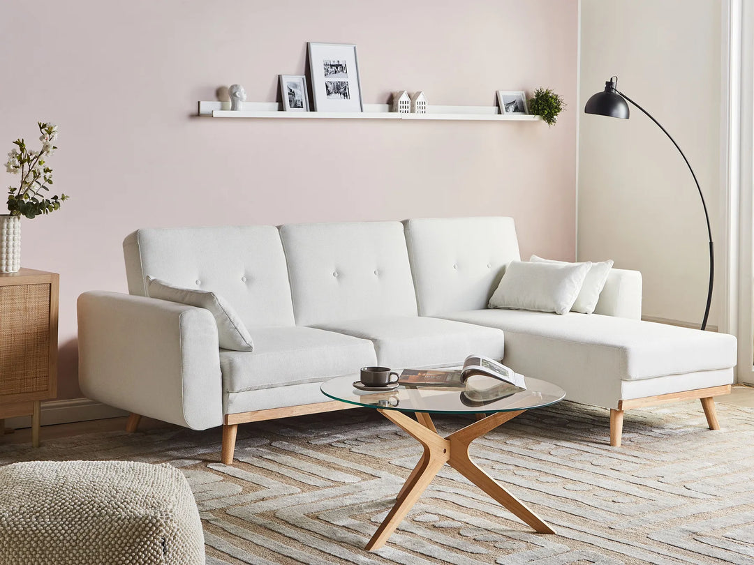 Modern living room with a white sofa, wooden coffee table, and decorative items.