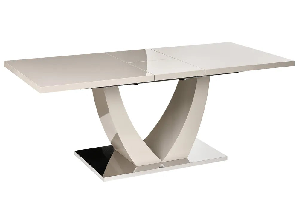 A modern rectangular dining table with a glossy light beige top and a sculptural chrome V-shaped pedestal base, shown on a plain white background.
