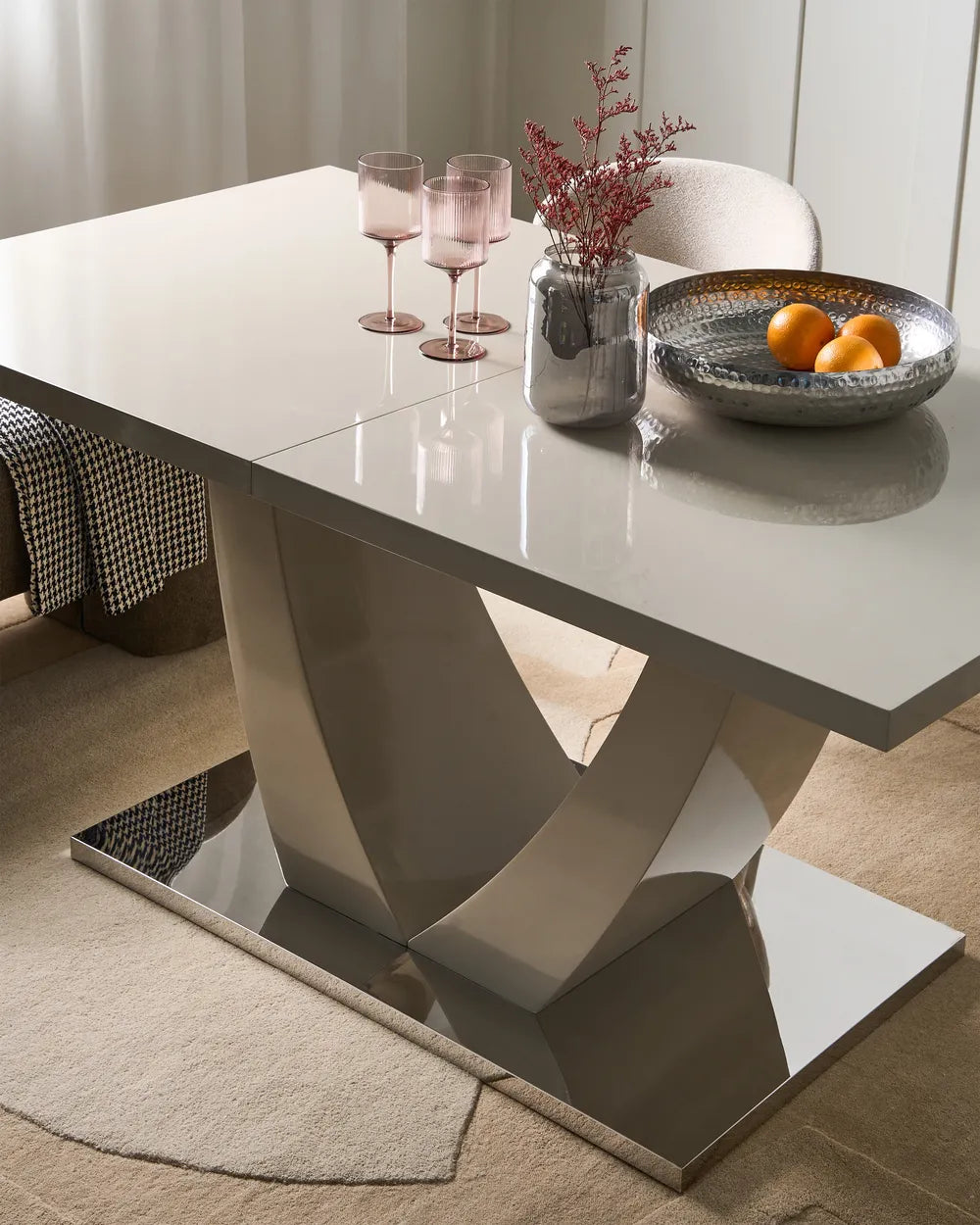 Modern dining table with decorative items in a room setting