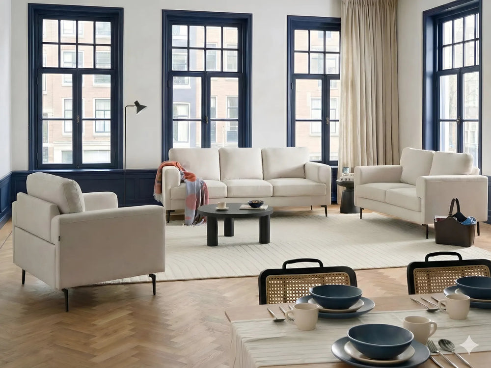 Modern living room with white sofas, a coffee table, and decorative items.