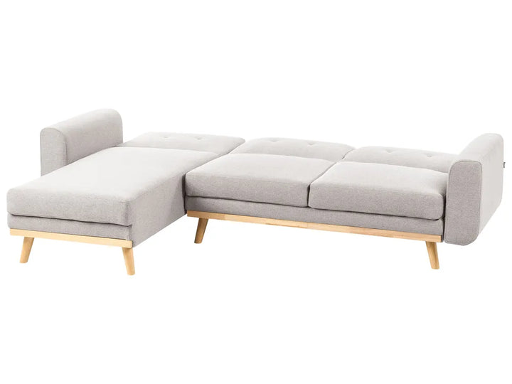 A light gray fabric sectional sofa with a chaise lounge on the left, featuring light natural wood legs and a matching wood frame, shown against a plain white background.