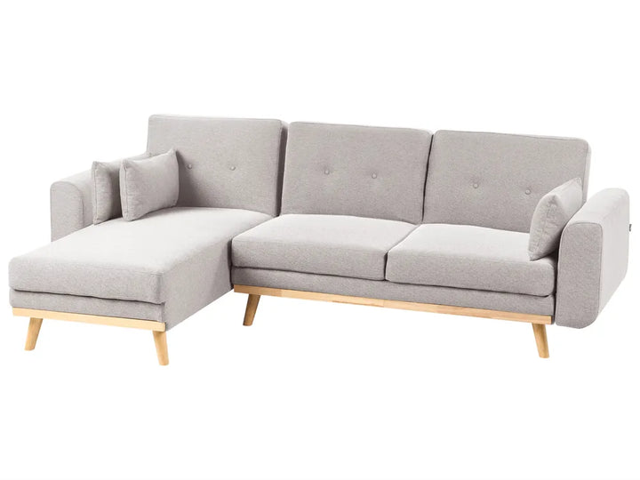 A light gray fabric sectional sofa with a left-facing chaise lounge, tufted back cushions, and light natural wood legs, shown against a plain white background.