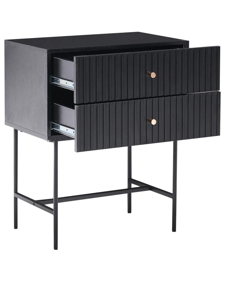 A modern black nightstand with two vertically-slatted drawers, one of which is partially open to show the drawer mechanism, supported by slim metal legs.