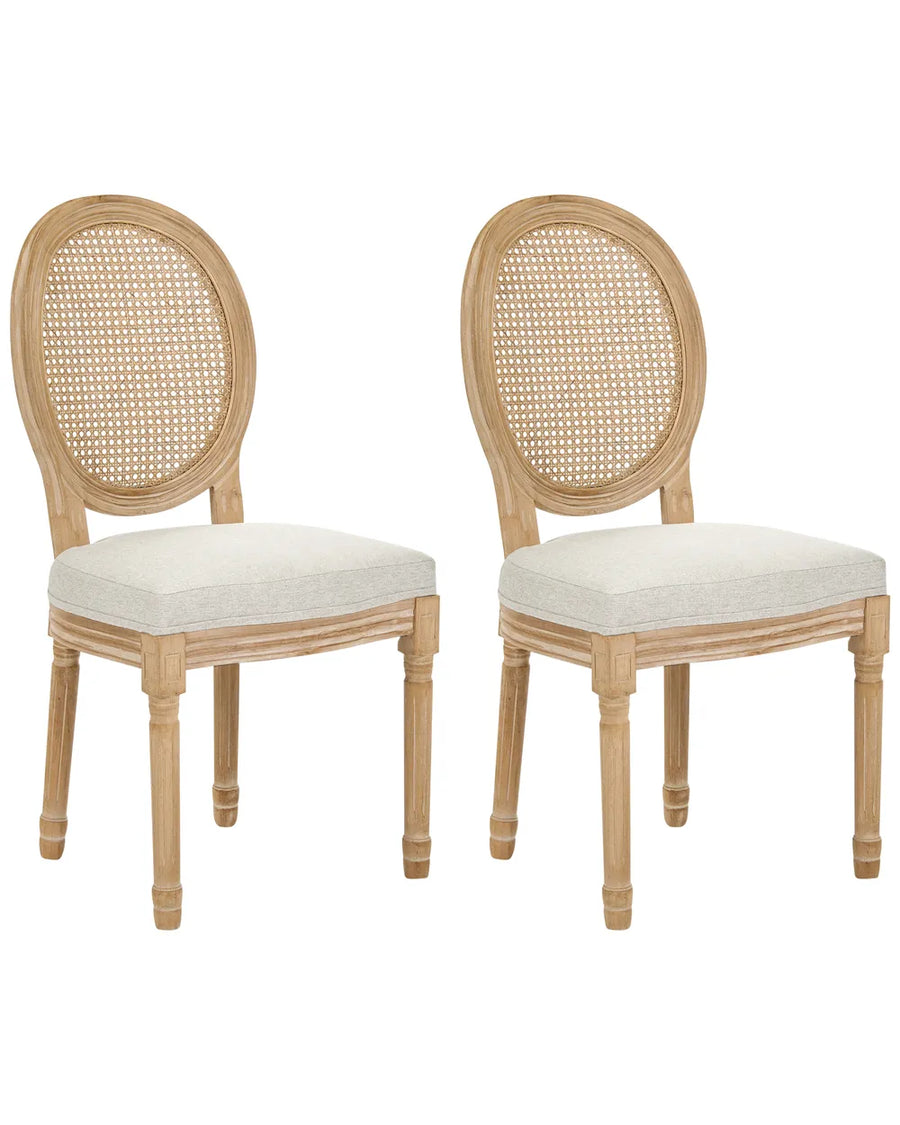 Two matching dining chairs with oval cane backrests and light beige upholstered seats, shown on a plain white background.