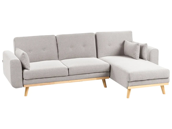 Gray sectional sofa with wooden legs on a white background