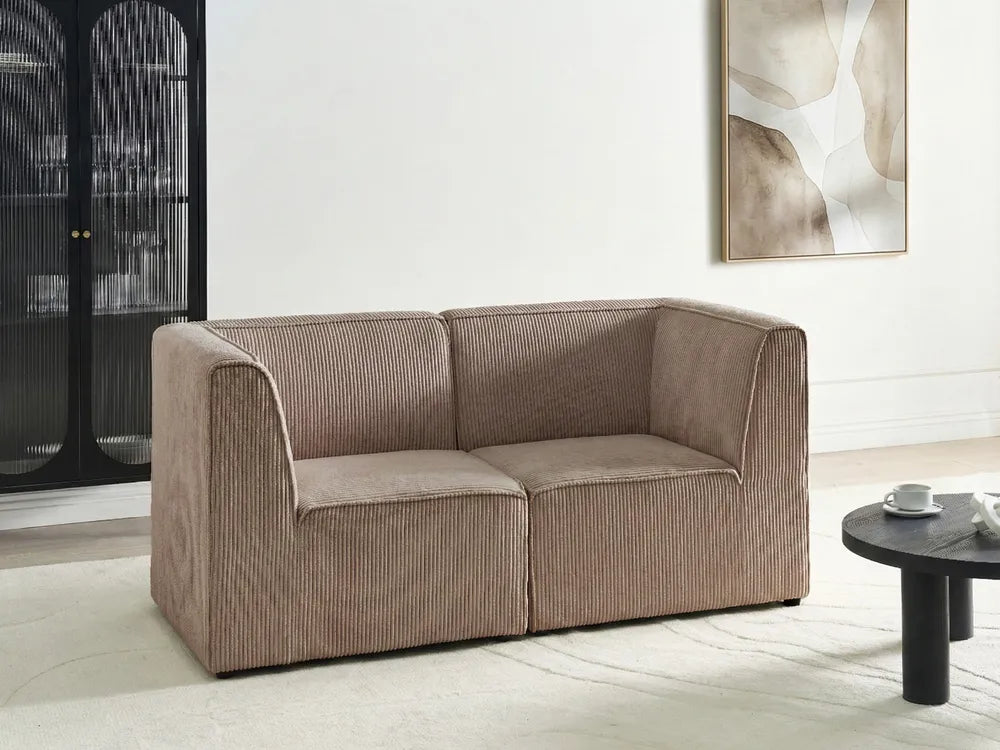 Beige sofa in a modern living room with a abstract painting on the wall.