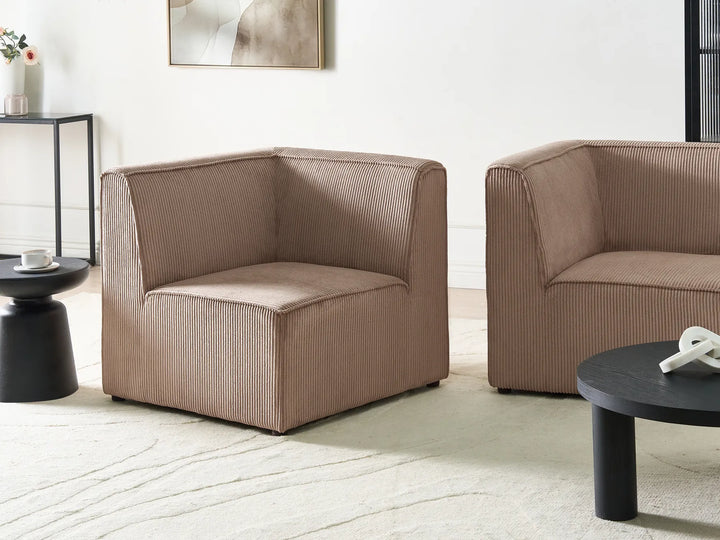 Two brown armchairs in a modern living room setting with a coffee table and decorative items.