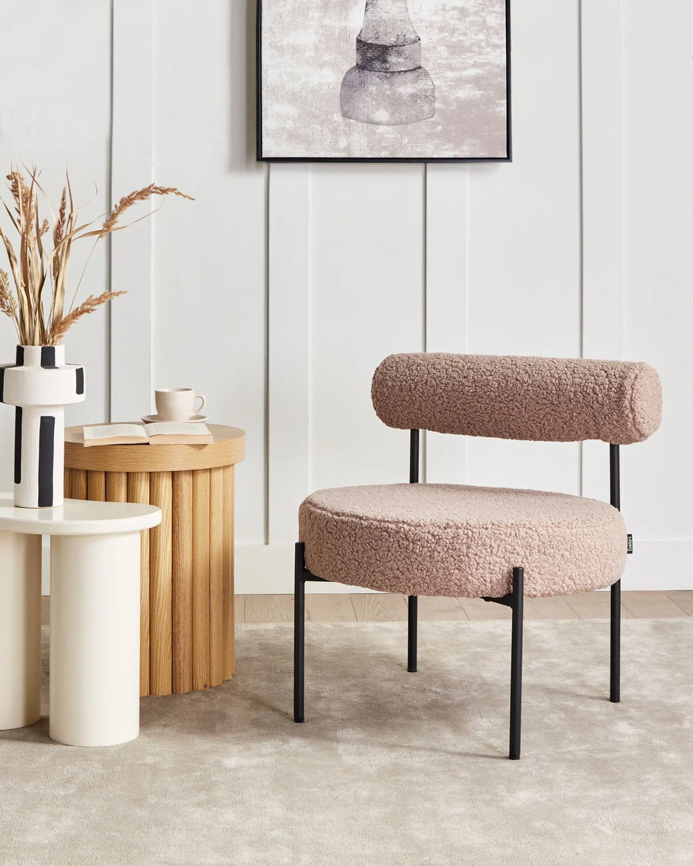 Modern chair with a textured cushion in a minimalistic room with side tables and decor.