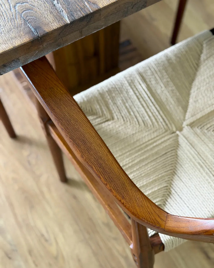 Wooden chair with a textured cushion on a wooden floor
