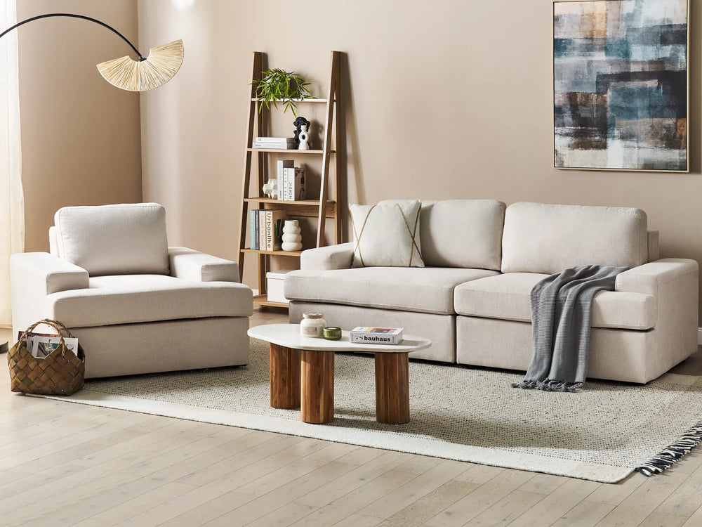 Modern living room with beige sofa, armchair, and wooden coffee table.