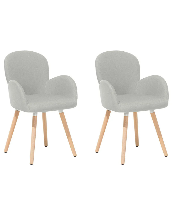 Two modern upholstered dining chairs with light gray fabric seats and curved wooden legs, shown side by side on a plain white background.