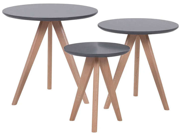 Three round nesting tables with dark gray tops and light natural wood legs, arranged on a plain white background.