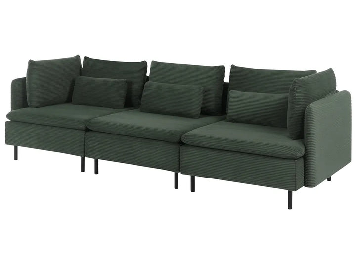 A dark green corduroy sectional sofa with matching back cushions and slim black legs, shown against a plain white background.