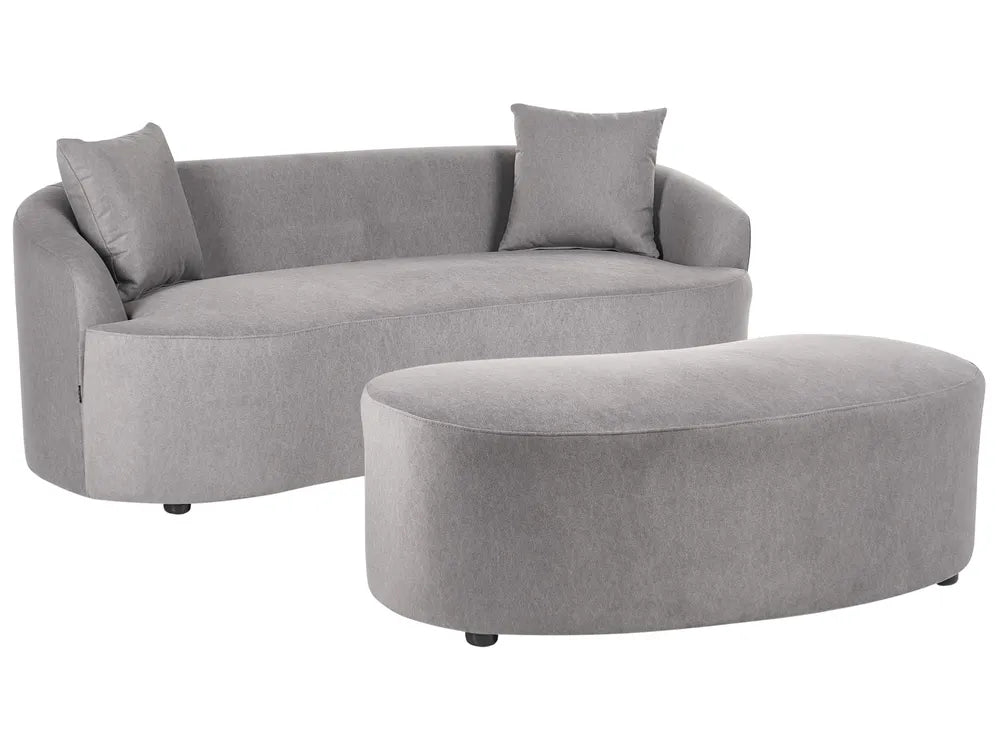 A light gray upholstered curved sofa with two matching throw pillows and a matching oval ottoman, shown on a plain white background.