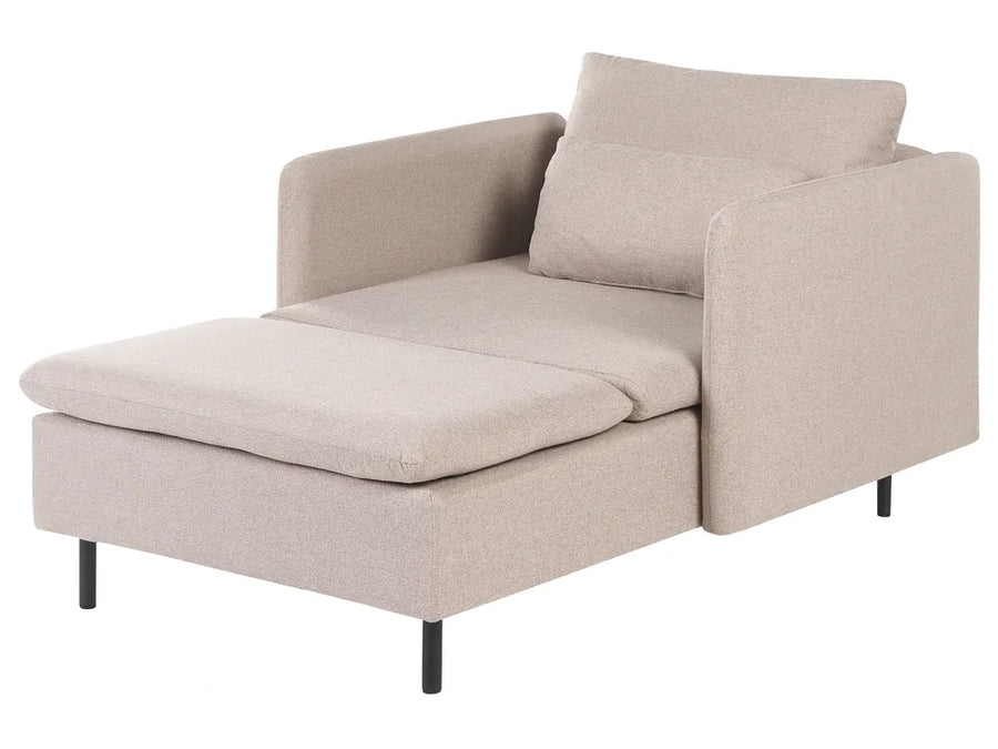 A modern chaise lounge chair in a light beige textured fabric, featuring a wide armrest, a matching back cushion, and a folded-out chaise lounge seat with slim black legs, shown against a plain white background.