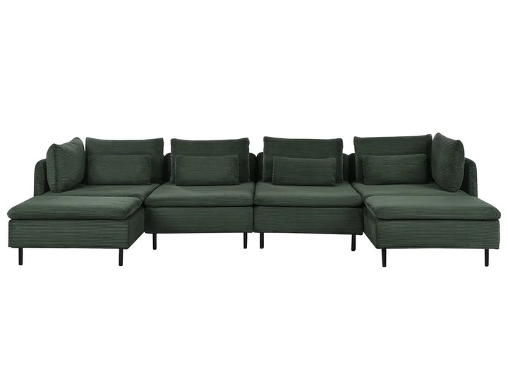 A dark green modular sectional sofa with multiple back cushions and a chaise lounge on the left, shown against a plain white background.
