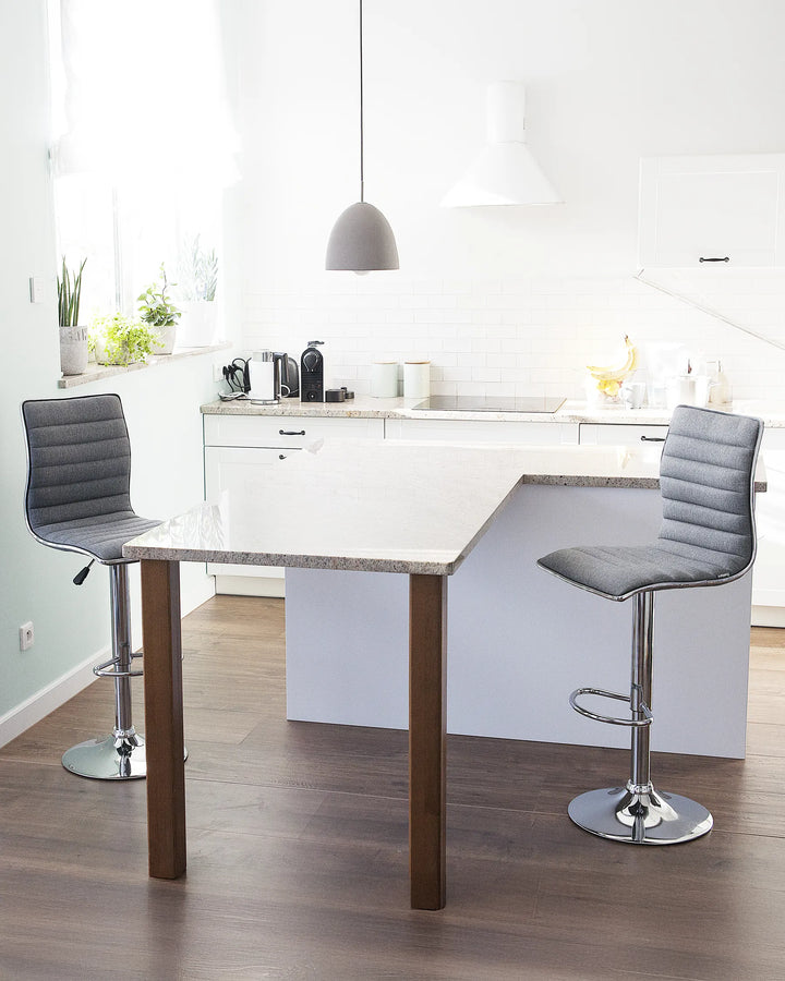 Modern kitchen with a dining table and gray chairs.
