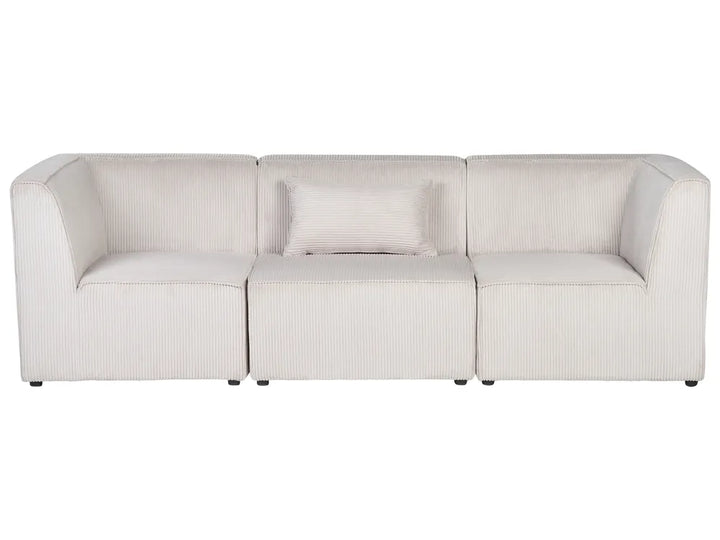 A modern three-seat modular sofa upholstered in a textured, ribbed cream fabric, featuring a matching throw pillow, set against a plain white background.