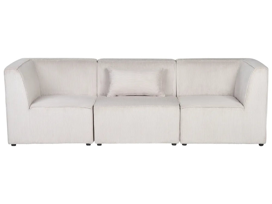 A modern three-seat modular sofa upholstered in a textured, ribbed cream fabric, featuring a matching throw pillow, set against a plain white background.