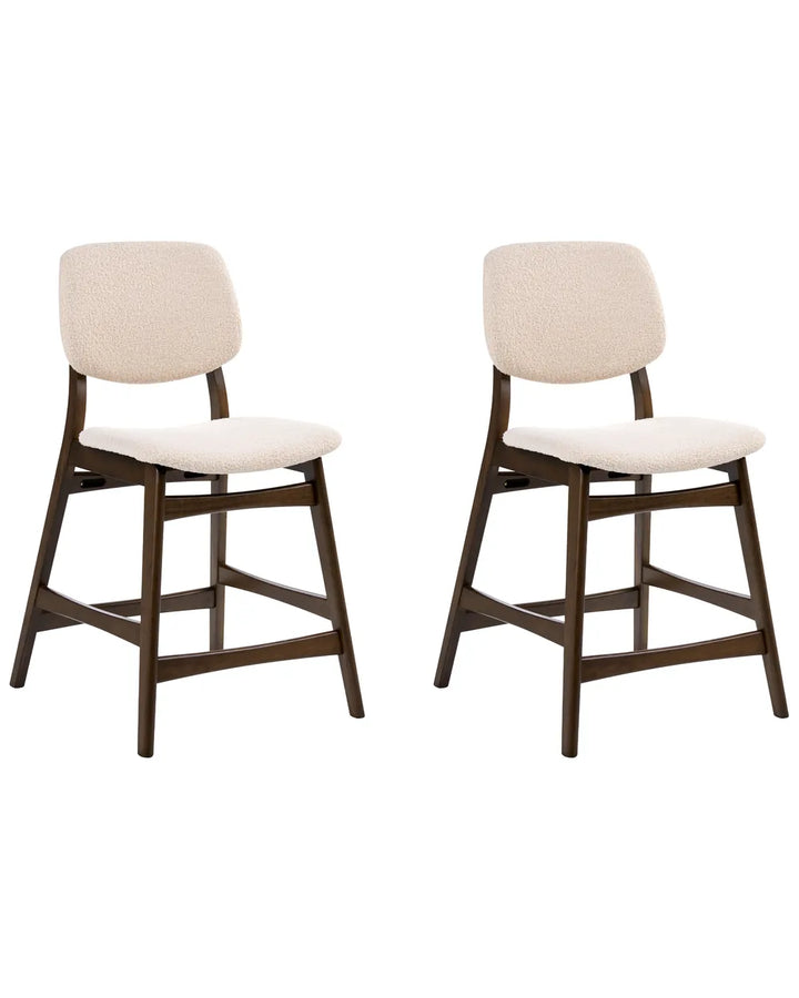 Two matching bar stools with dark brown wooden frames and cream-colored textured upholstered seats and backs, shown side by side on a plain white background.