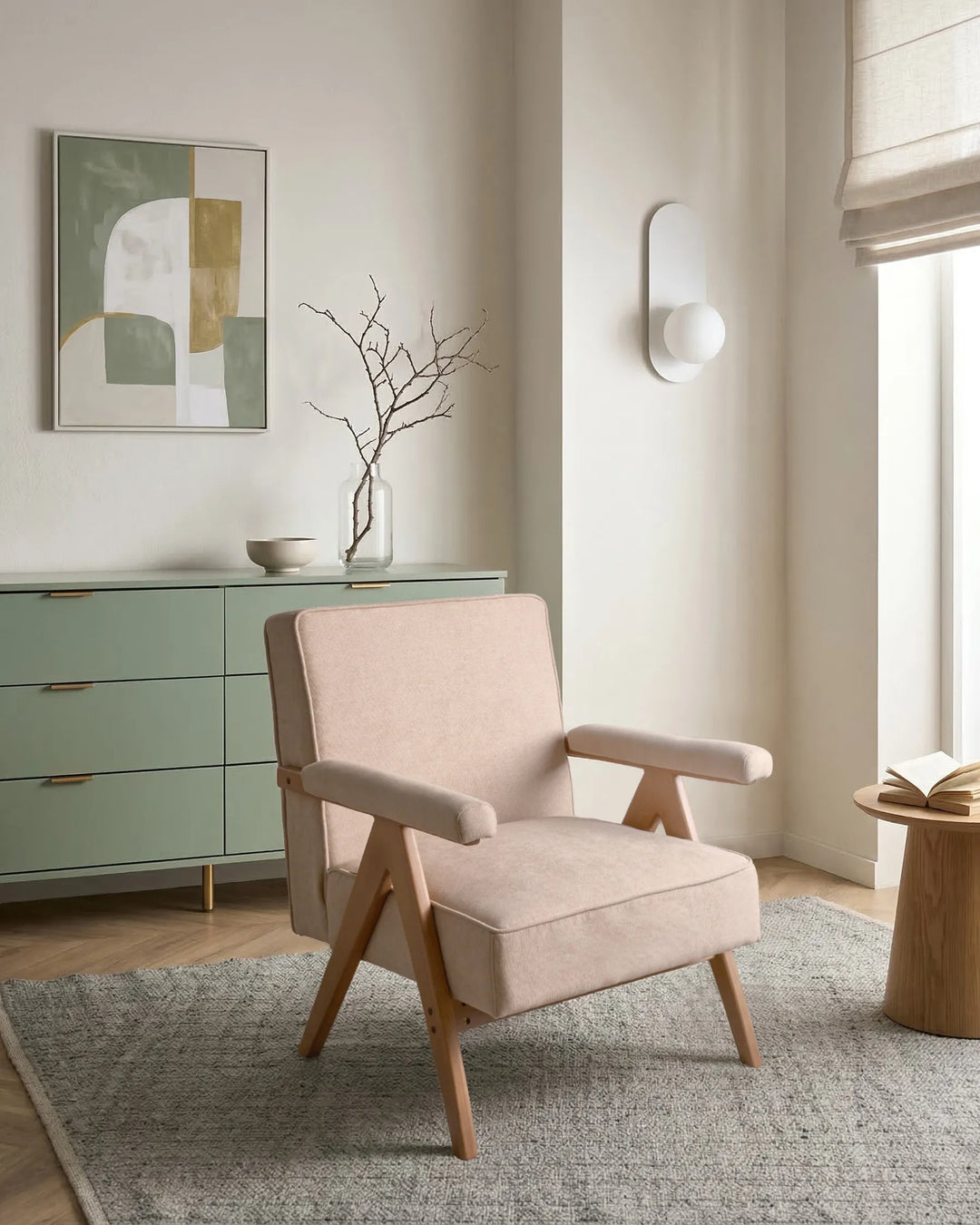 Beige armchair in a modern living room with a green cabinet and abstract art on the wall.