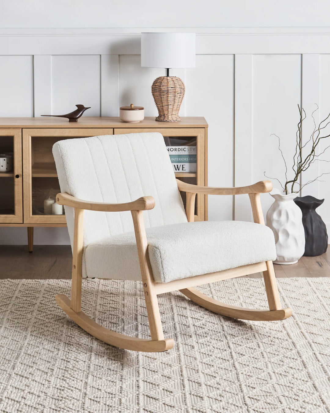 White rocking chair in a room with wooden furniture and decor.