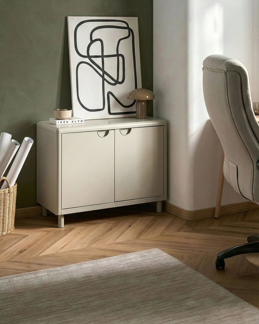 Beige sideboard with abstract art in a room with a chair and basket.
